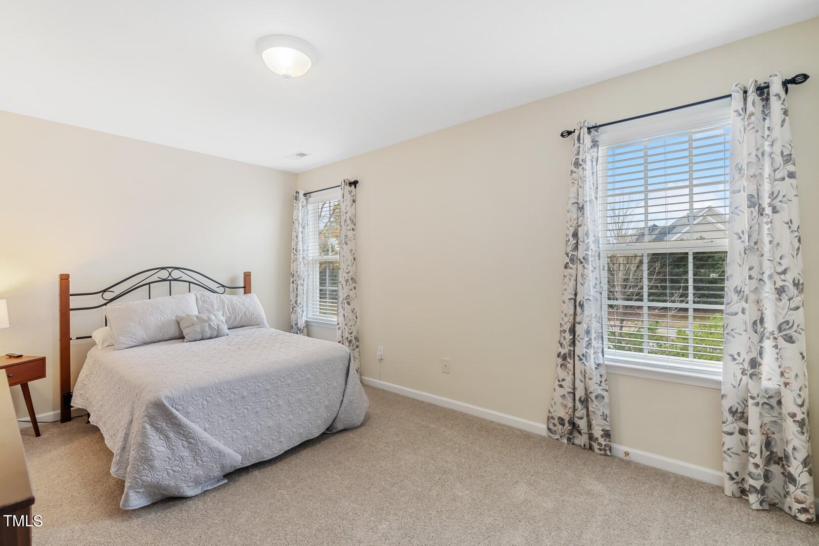12219 Fox Valley Street Raleigh, NC 27614 - Photo 26 of 36 a bedroom with a bed and a window
