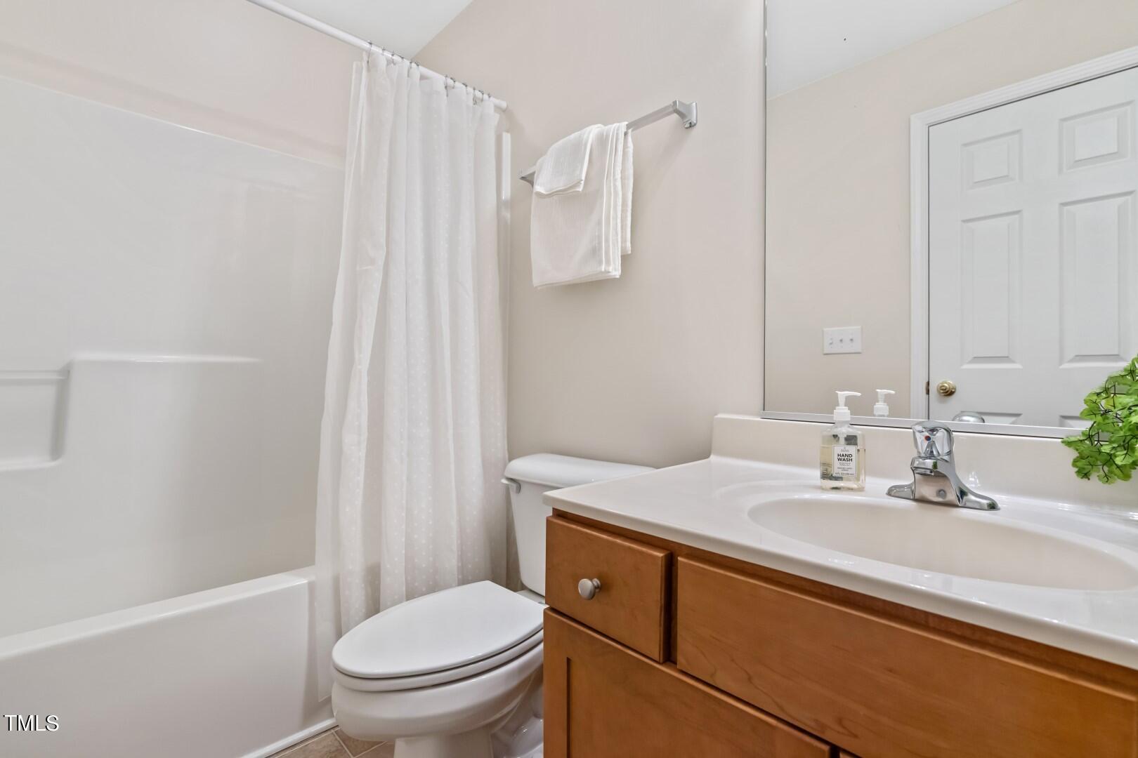 12219 Fox Valley Street Raleigh, NC 27614 - Photo 28 of 36 a bathroom with a sink a toilet and shower