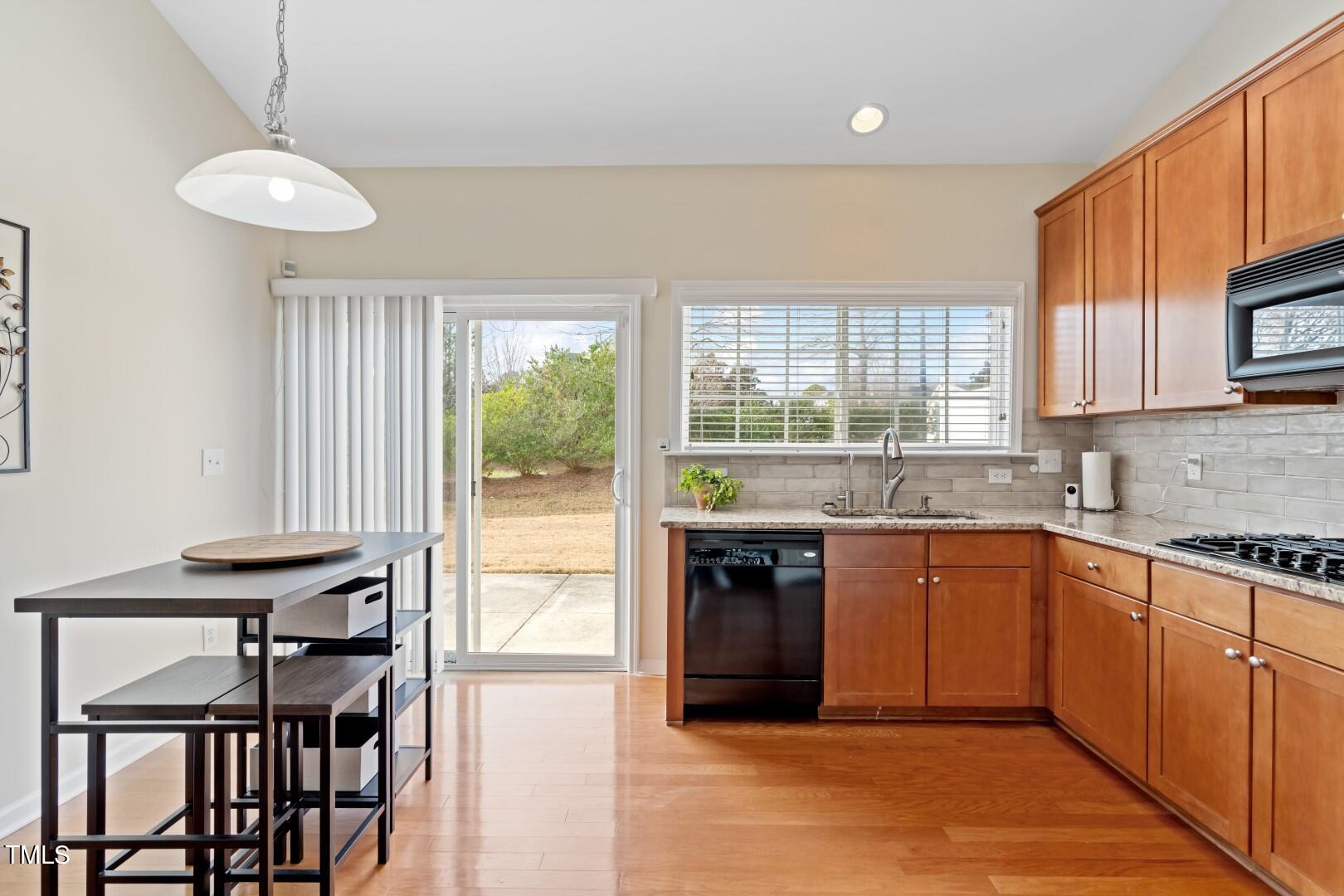12219 Fox Valley Street Raleigh, NC 27614 - Photo 3 of 36 a kitchen with a table chairs sink and cabinets
