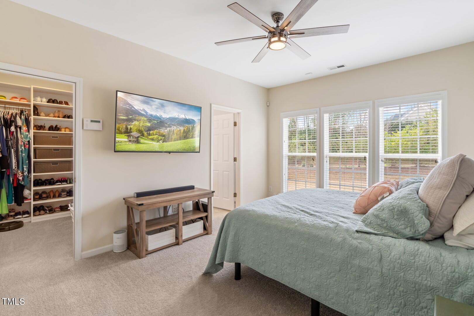 12219 Fox Valley Street Raleigh, NC 27614 - Photo 4 of 36 a bedroom with a bed and a window