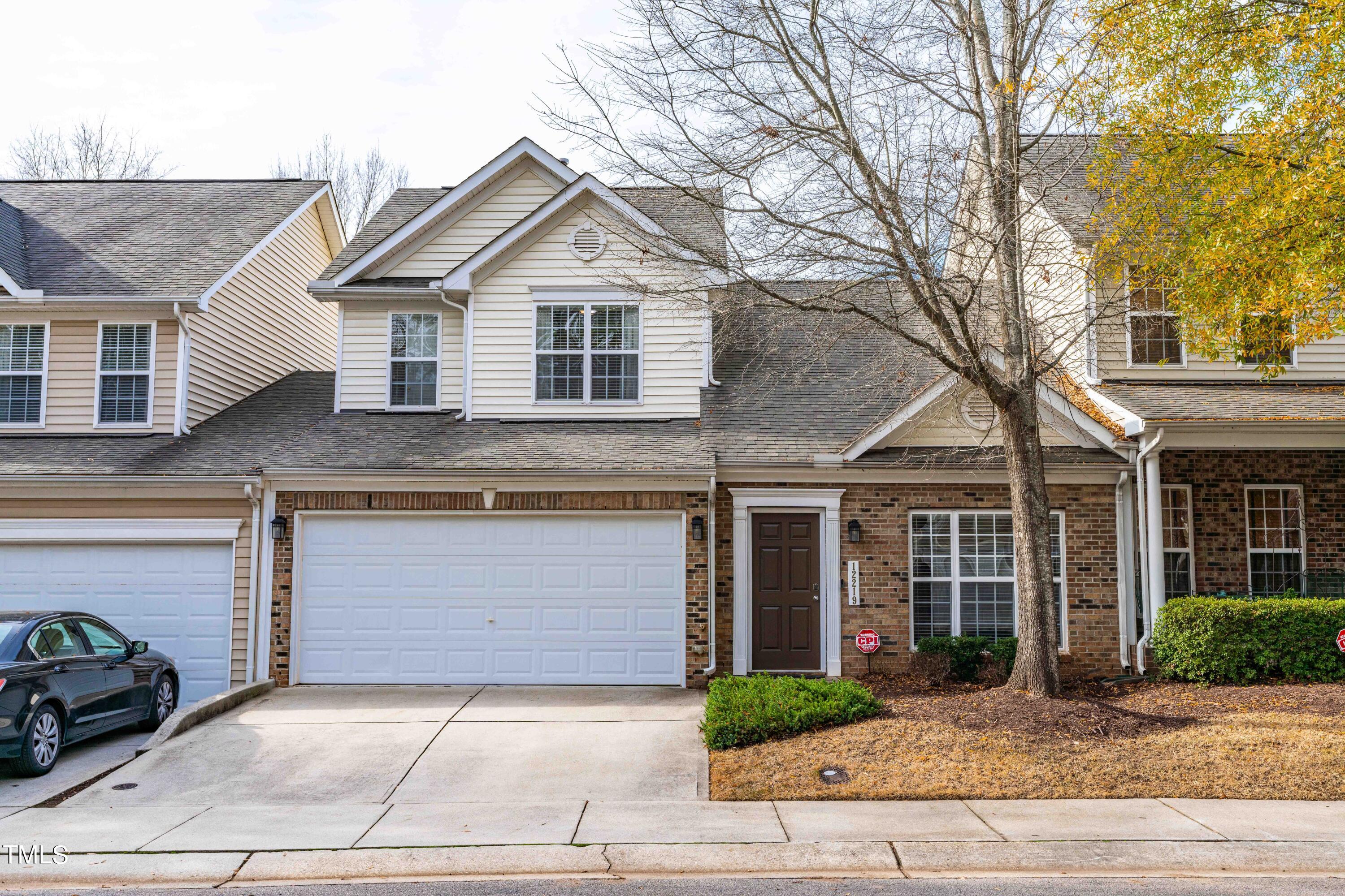 12219 Fox Valley Street Raleigh, NC 27614 - Photo 5 of 36 a front view of a house with garage and plants