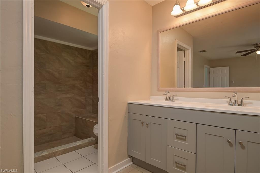 17437 Lee Road Fort Myers, FL 33967 - Photo 12 of 23 a bathroom with a shower sink and mirror