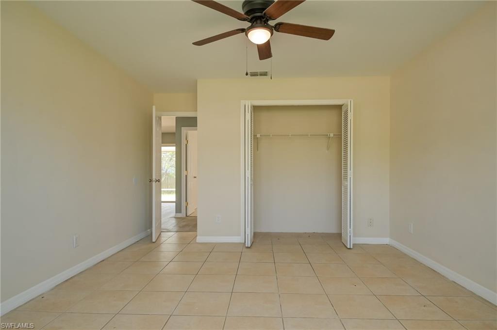 17437 Lee Road Fort Myers, FL 33967 - Photo 15 of 23 an empty room with closet and a ceiling fan