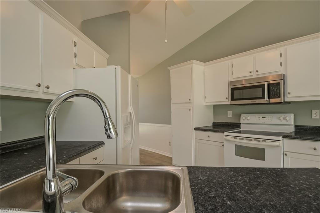 17437 Lee Road Fort Myers, FL 33967 - Photo 5 of 23 a kitchen with a sink a stove and cabinets
