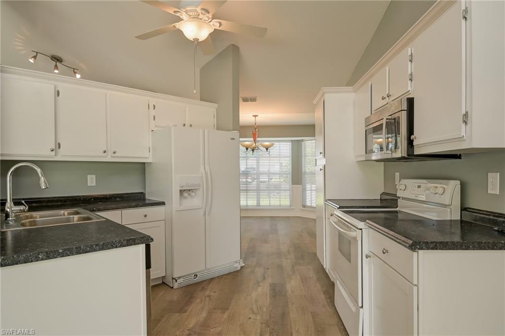 17437 Lee Road Fort Myers, FL 33967 - Photo 7 of 23 a kitchen with stainless steel appliances granite countertop a sink stove and refrigerator