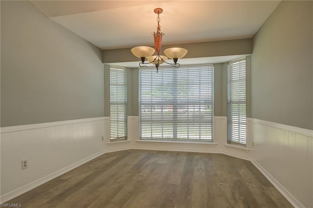 17437 Lee Road Fort Myers, FL 33967 - Photo 9 of 23 a view of an empty room with wooden floor and windows