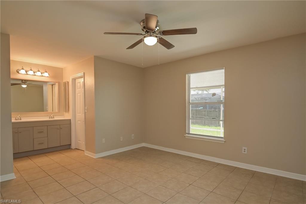 17437 Lee Road Fort Myers, FL 33967 - Photo 10 of 23 a view of an empty room and window and a kitchen