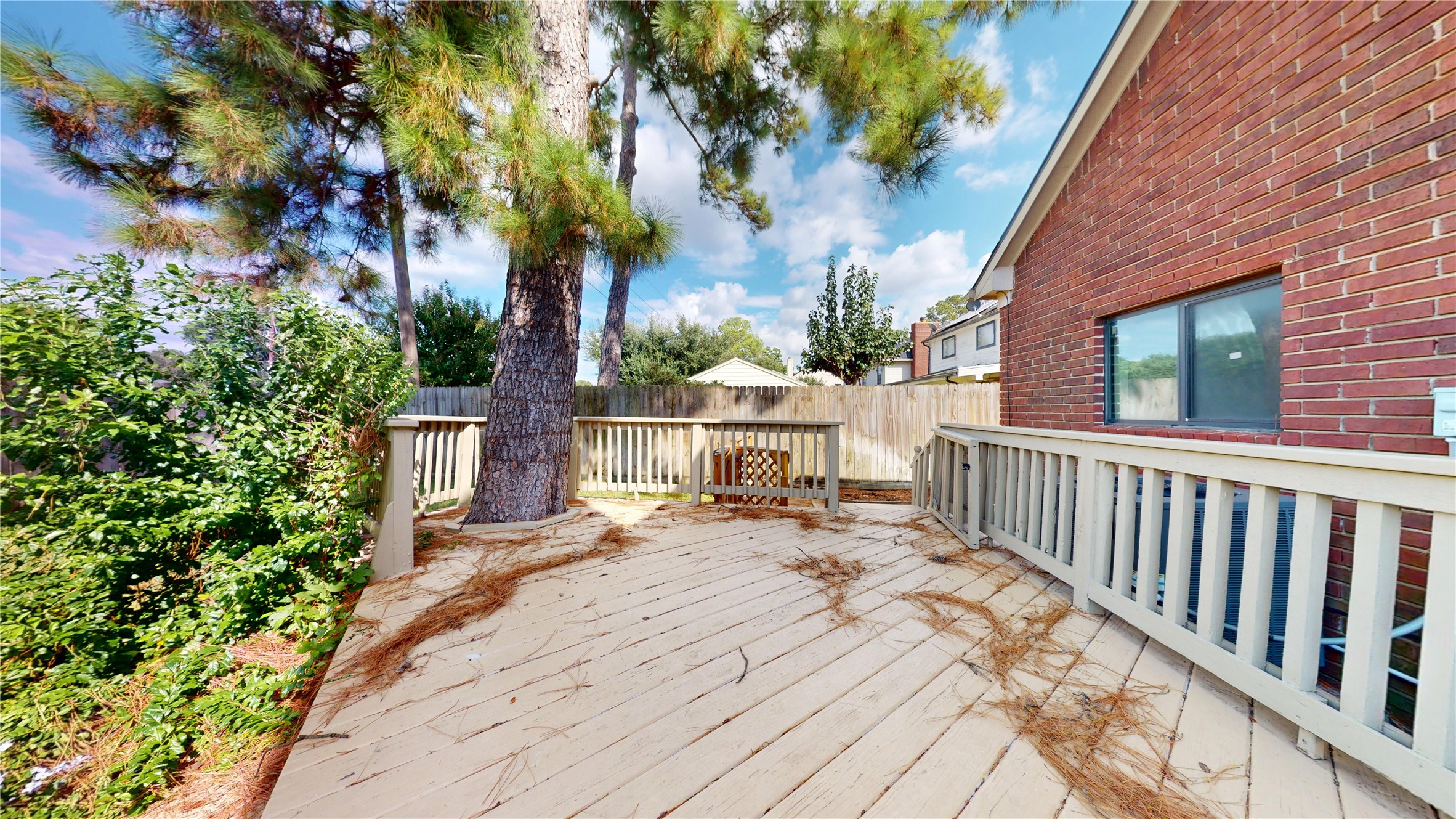 16418 Rainbow Lake Road Houston, TX 77095 - Photo 39 of 47 Beautifully refinished deck creates a fresh, inviting outdoor space perfect for relaxing or entertaining while overlooking the spacious backyard.