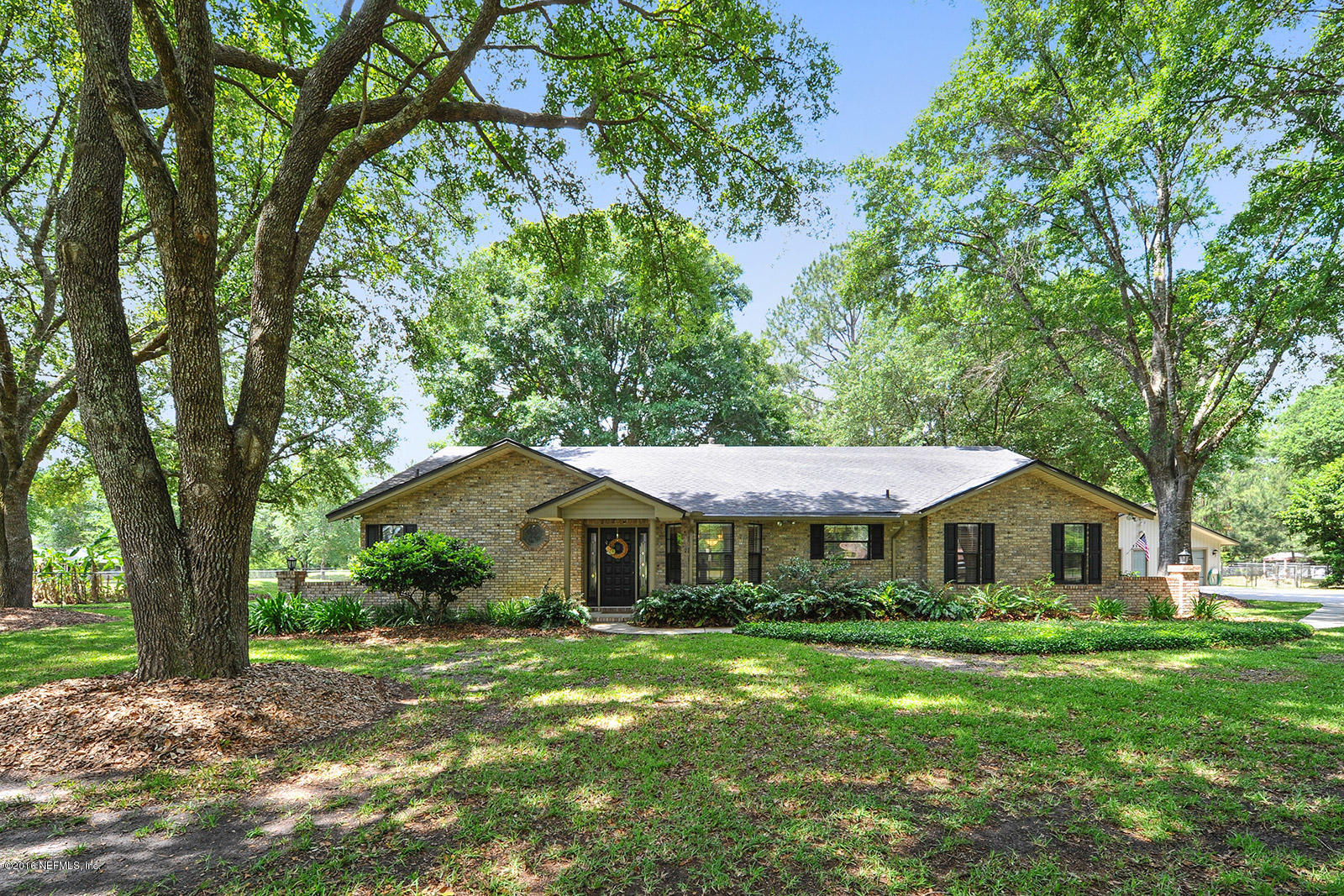 55481 Deer Run Road Callahan, FL 32011 - Photo 1 of 26 a front view of a house with yard and green space