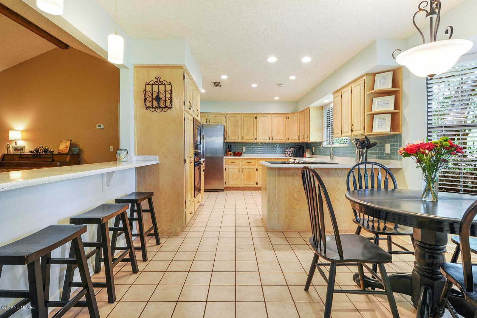 55481 Deer Run Road Callahan, FL 32011 - Photo 2 of 26 a kitchen with granite countertop kitchen island stainless steel appliances a table and chairs in it