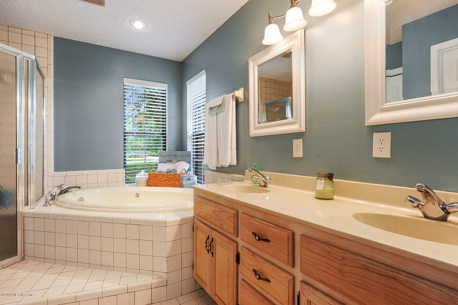 55481 Deer Run Road Callahan, FL 32011 - Photo 11 of 26 a bathroom with a tub sink and mirror
