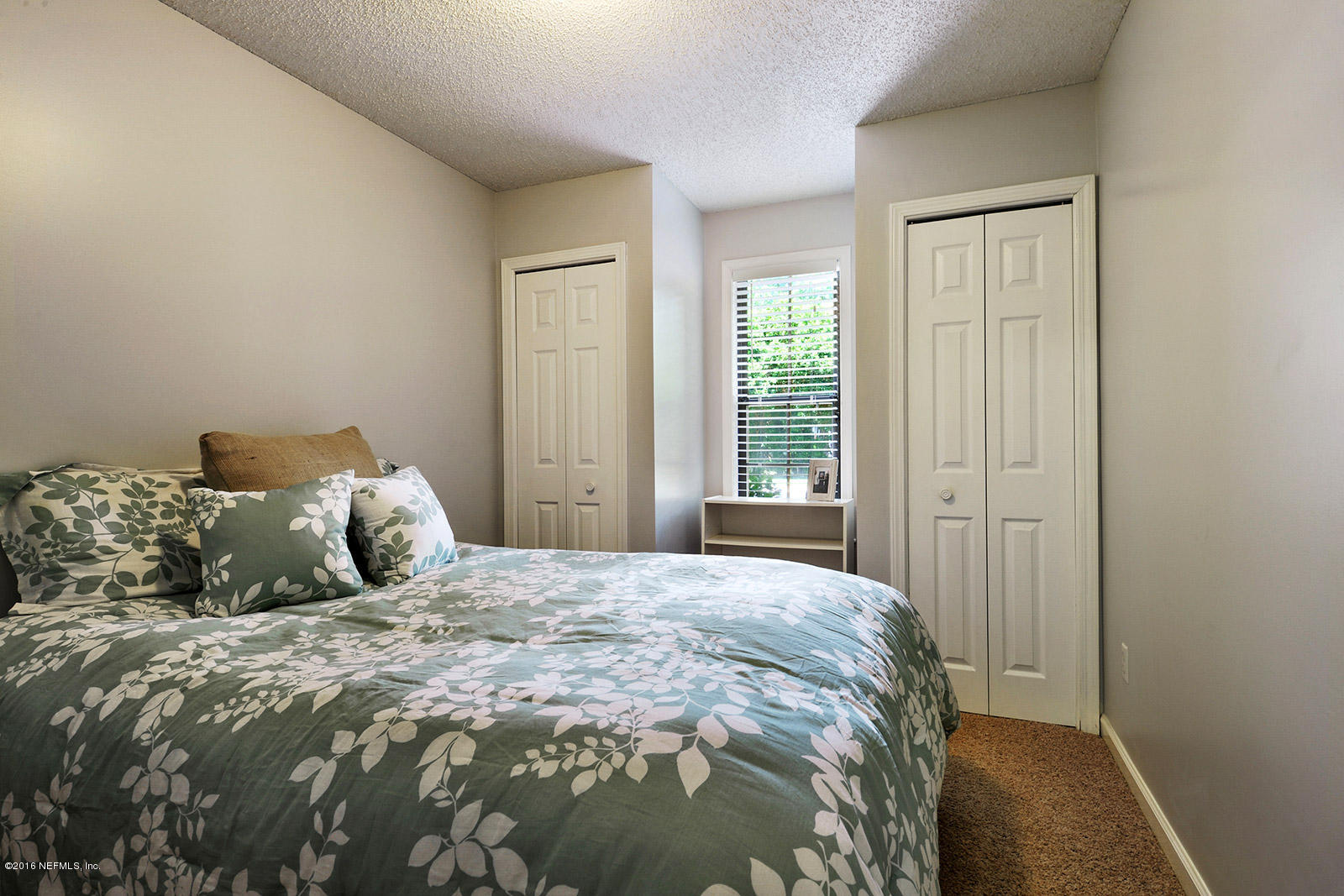55481 Deer Run Road Callahan, FL 32011 - Photo 16 of 26 a bedroom with a large bed and wooden floor