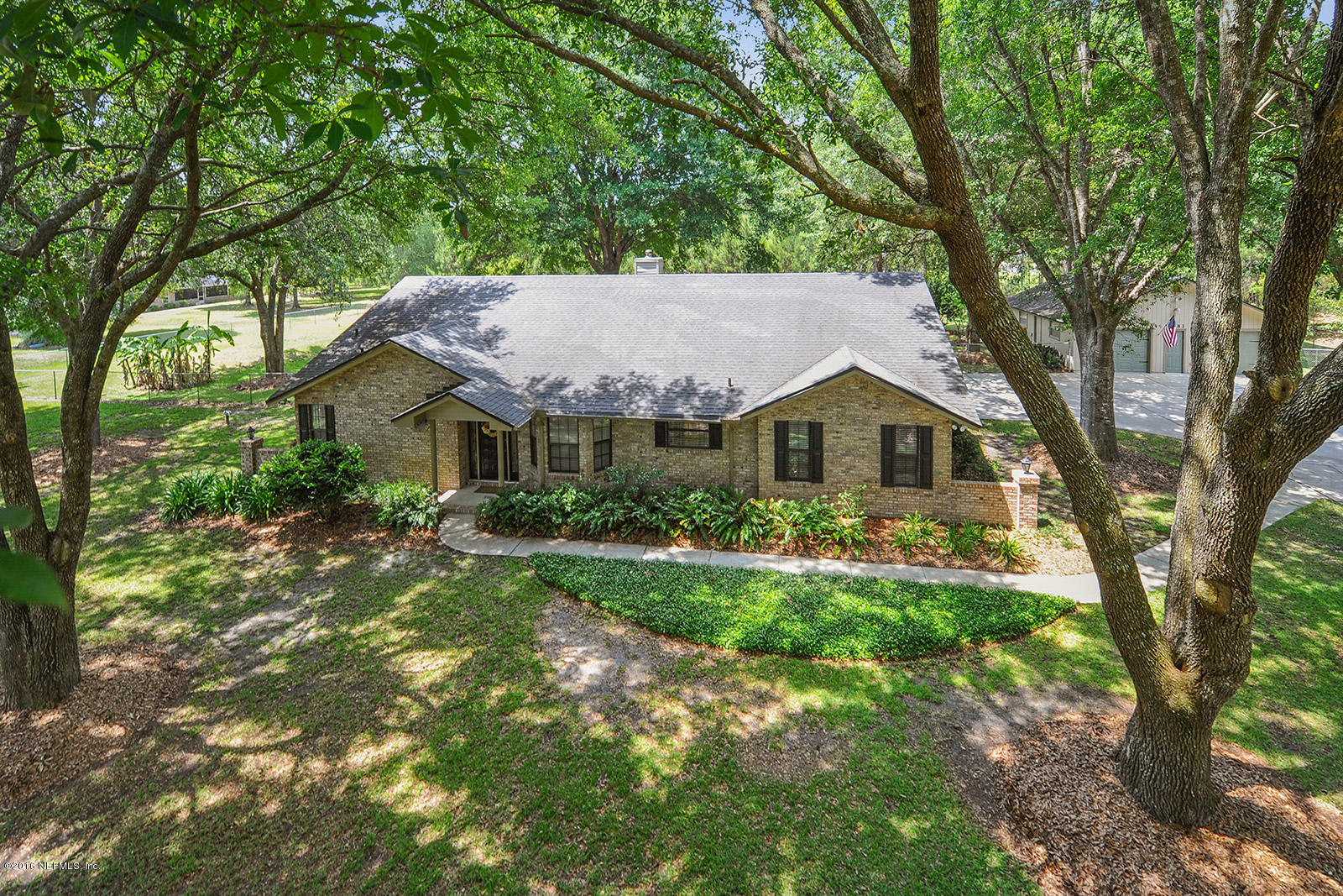 55481 Deer Run Road Callahan, FL 32011 - Photo 24 of 26 a front view of a house with yard and green space