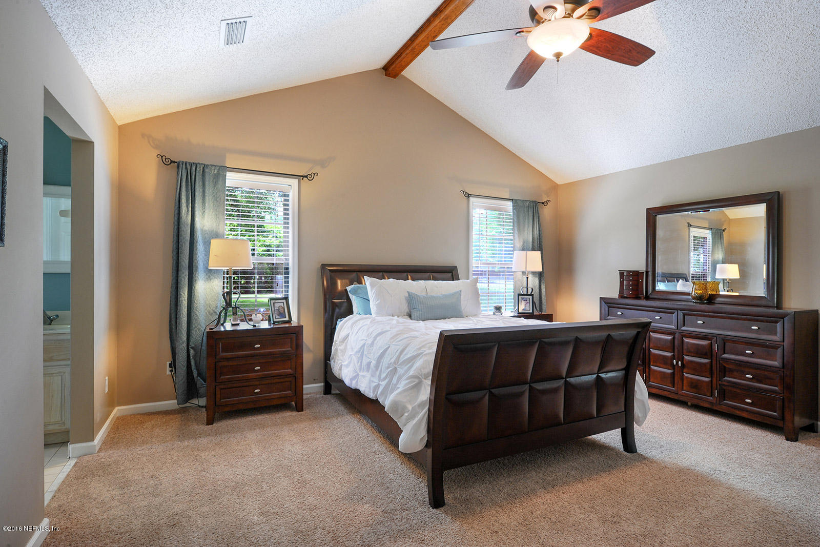 55481 Deer Run Road Callahan, FL 32011 - Photo 9 of 26 a bedroom with a bed and a chandelier