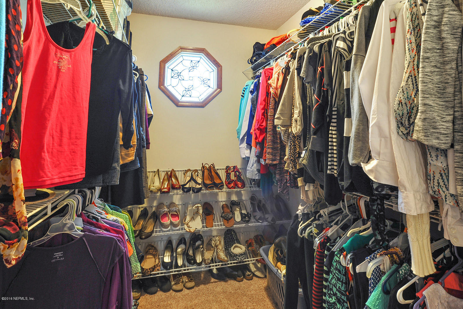 55481 Deer Run Road Callahan, FL 32011 - Photo 10 of 26 a view of walk in closet with clothes