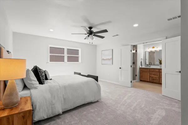 a bedroom with a bed and a chandelier