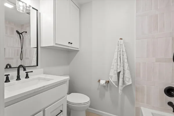 a bathroom with a sink a toilet and shower