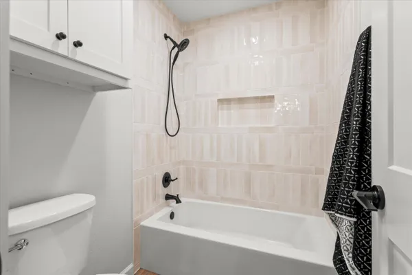 a bathroom with a bathtub a toilet and a shower