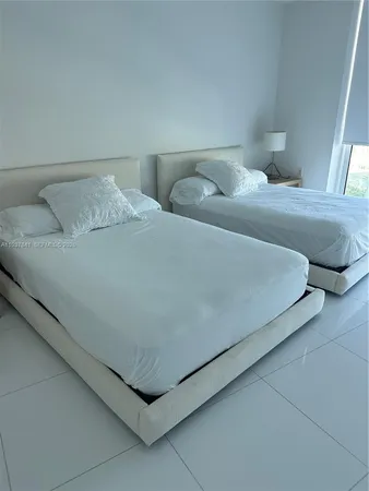 a bedroom with a bed and lamp
