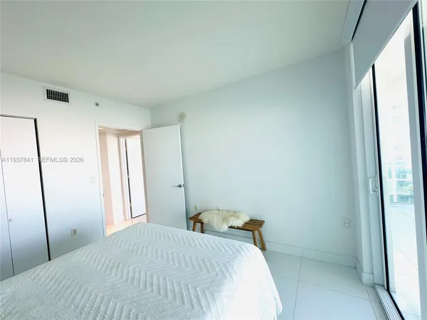 a bedroom with a bed and a shower