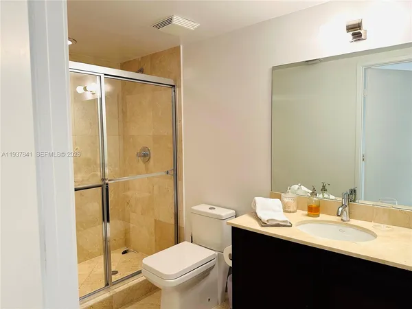 a bathroom with a sink toilet and shower