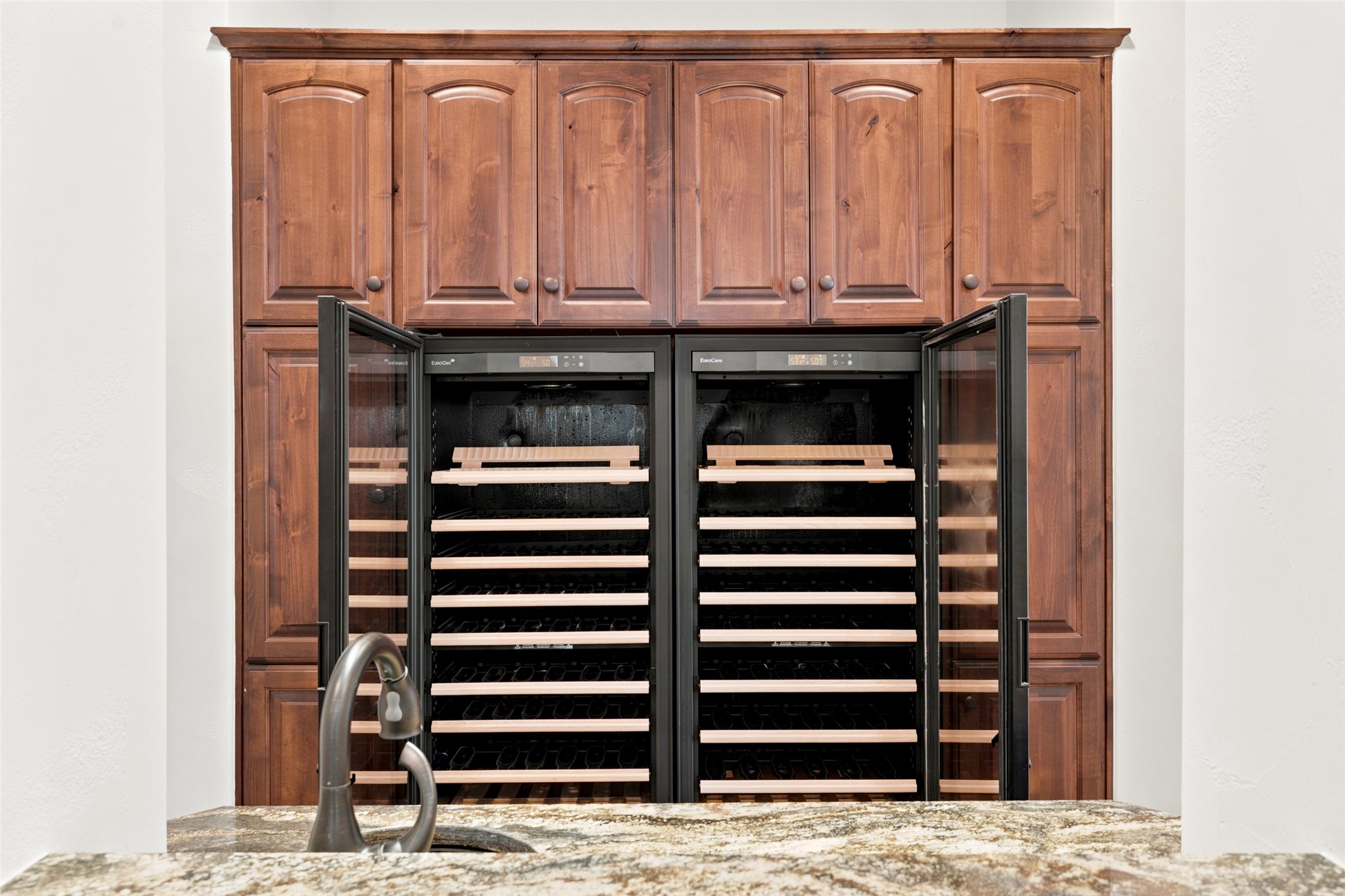 1414 The High Road Austin, TX 78746 - Photo 14 of 40 Double wine refrigerators and rich wood cabinetry create a sophisticated beverage station.
