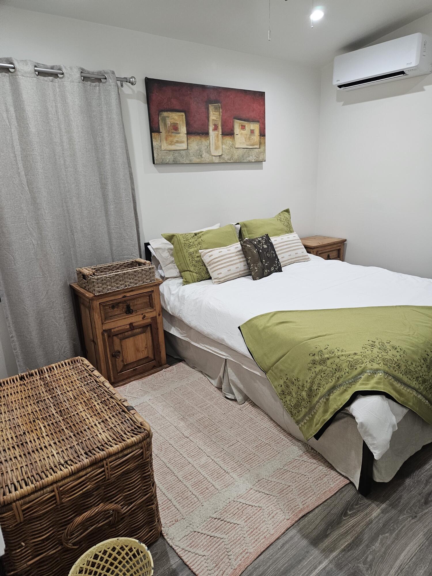 4884 Avenida Del Sol Joshua Tree, CA 92252 - Photo 16 of 18 a bedroom with a bed and a dresser