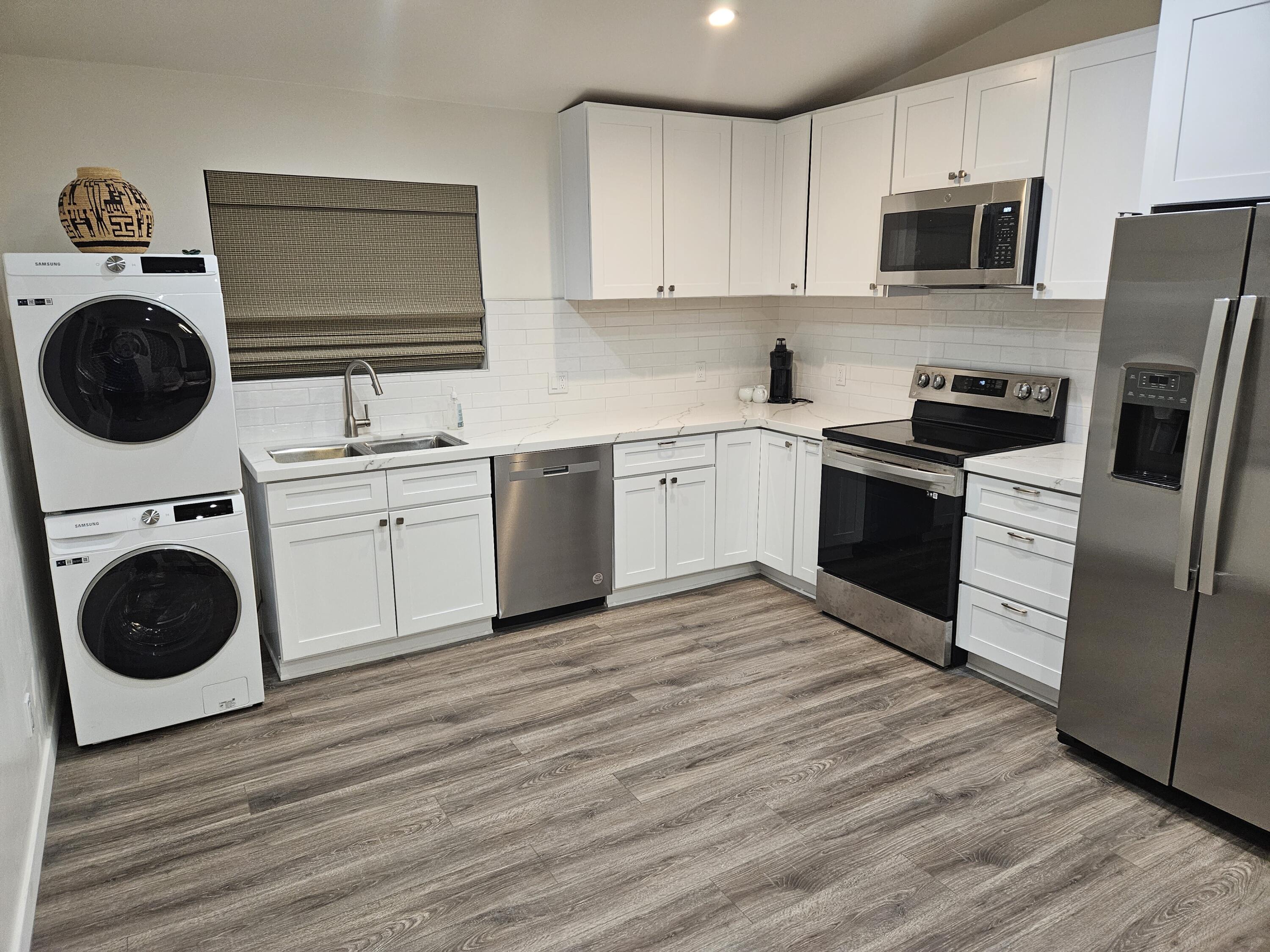 4884 Avenida Del Sol Joshua Tree, CA 92252 - Photo 3 of 18 a kitchen with a sink a stove and cabinets
