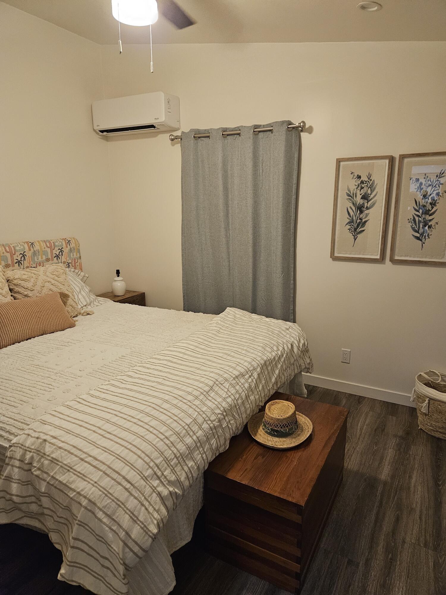 4884 Avenida Del Sol Joshua Tree, CA 92252 - Photo 5 of 18 a bedroom with a bed and a painting on the wall