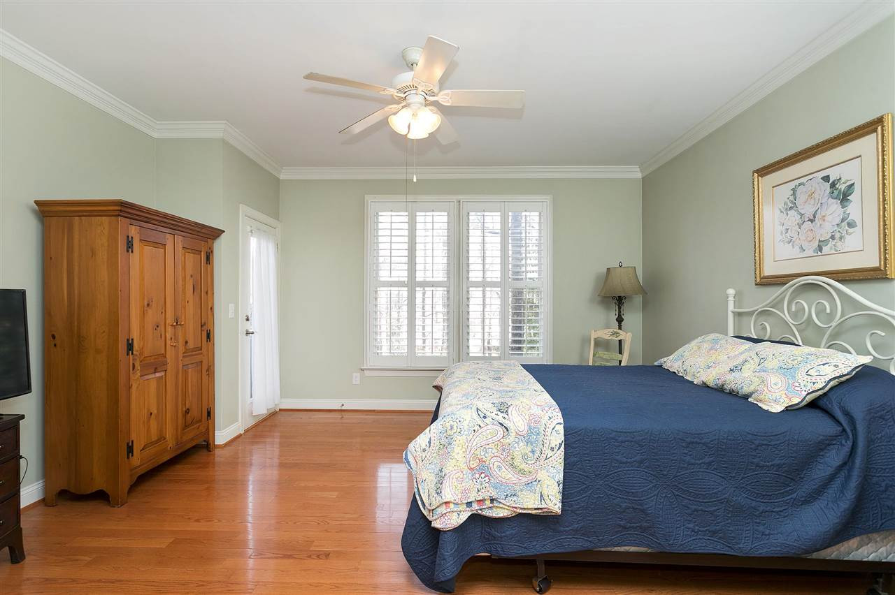 8216 Lloyd Allyns Way Raleigh, NC 27615 - Photo 9 of 30 Main level Owner's Suite w 2 WIC's opens onto deck. Master Bedroom