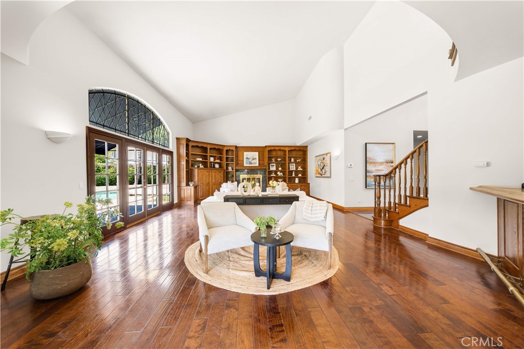 519 Connie Rae Way Arcadia, CA 91006 - Photo 28 of 71 a dining room with wooden floor a chandelier a glass table and chairs