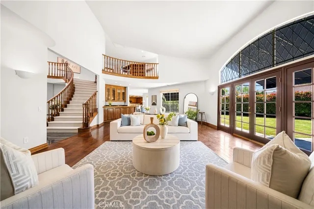 a view of staircase with lots of frames on wall and a chandelier
