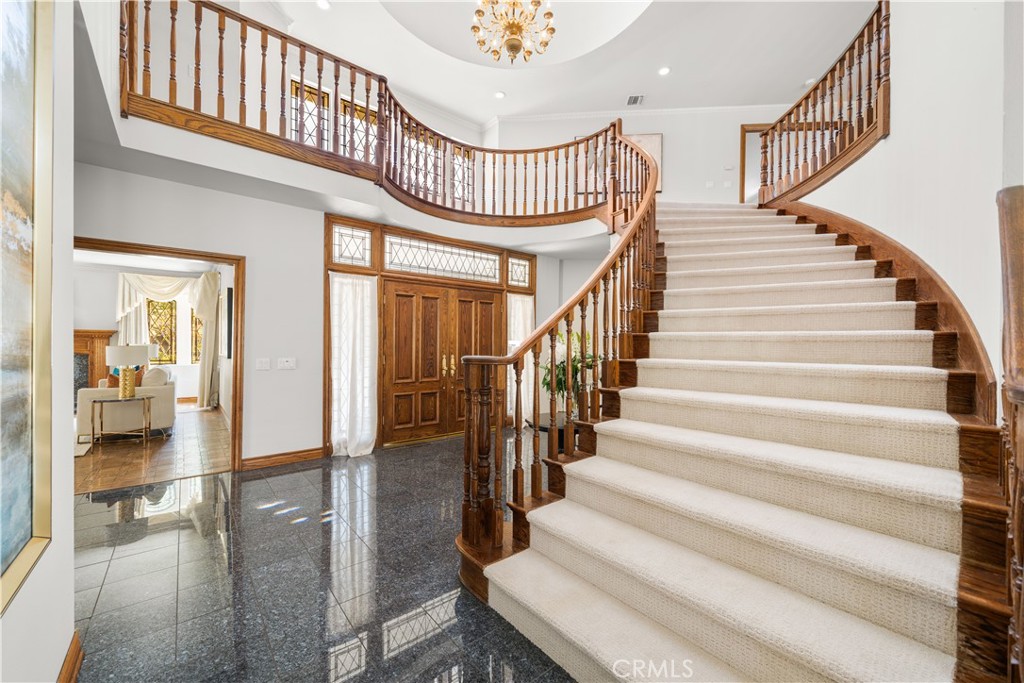 519 Connie Rae Way Arcadia, CA 91006 - Photo 42 of 71 a view of staircase with lots of frames on wall and a chandelier