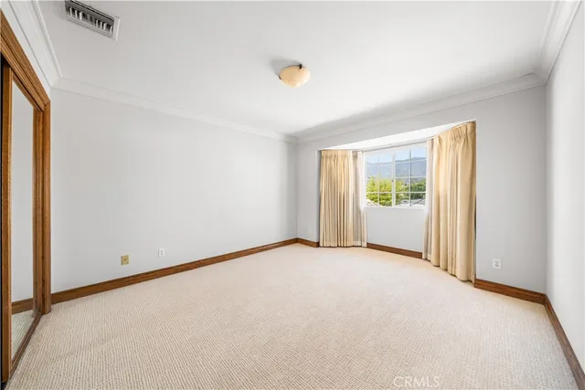 a large white room with a large mirror and double vanity