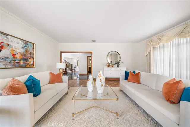 a living room with furniture a rug and a window