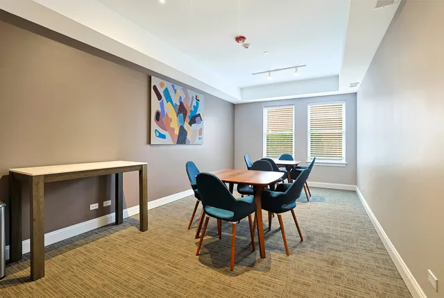 a view of a dining room with furniture and window