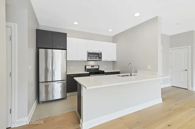 a kitchen with stainless steel appliances a refrigerator sink and microwave