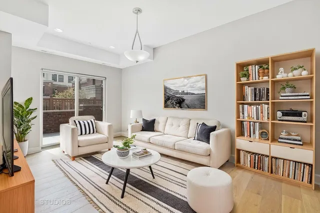 a living room with furniture and a book shelf