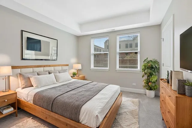 a bedroom with bed and a flat screen tv