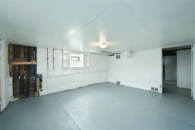 an empty room with closet and windows