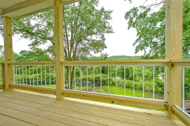 a view of balcony with wooden floor