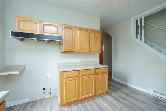 a view of a kitchen with wooden floor