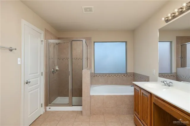 a bathroom with a tub sink and shower