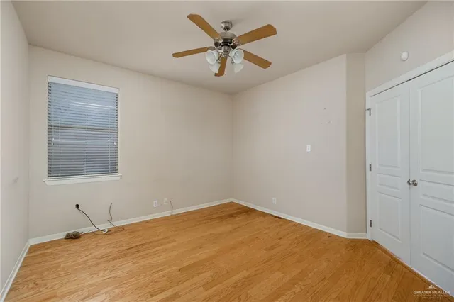 a view of a room with a bed and a ceiling fan