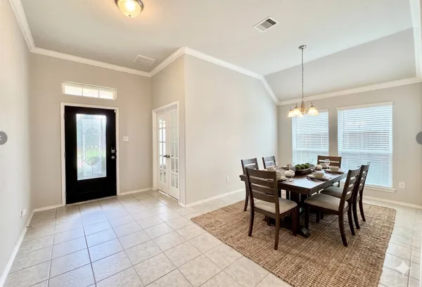 a view of a dining room with furniture and window