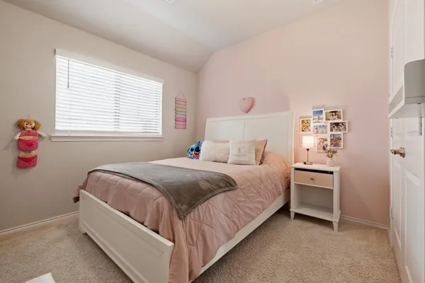 a bed room with a bed and a window