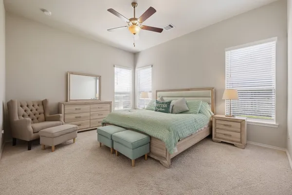 a spacious bedroom with a bed and a couch