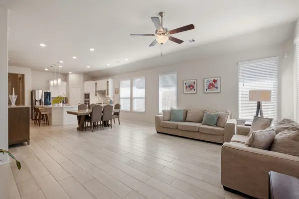 a living room with furniture and view of kitchen