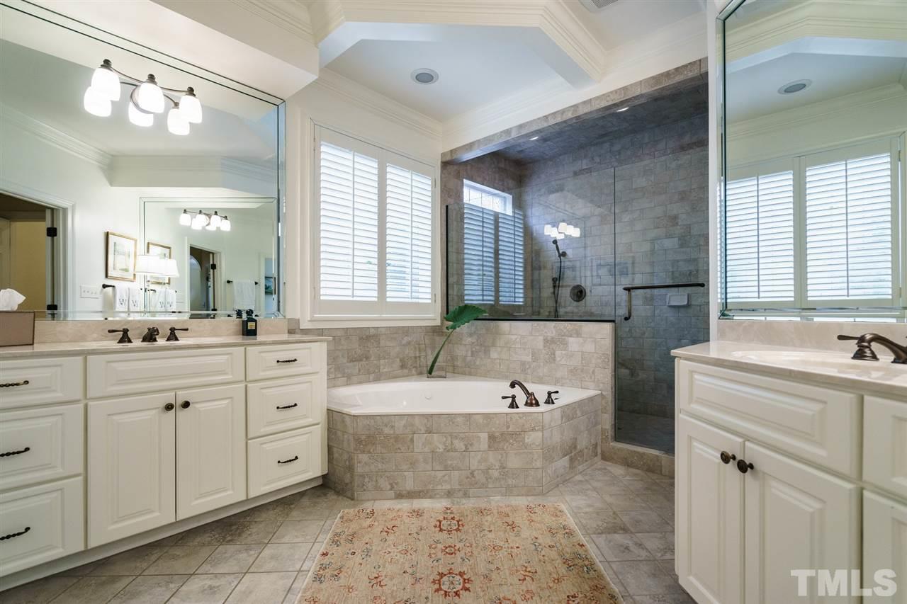 1820 Torrington Street Raleigh, NC 27615 - Photo 15 of 25 a spacious bathroom with a tub sink and mirror