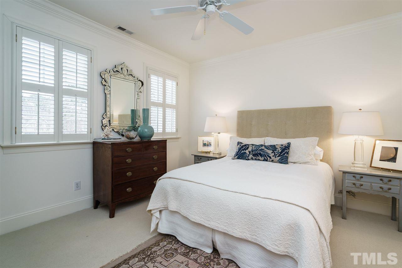 1820 Torrington Street Raleigh, NC 27615 - Photo 21 of 25 a bedroom with a bed and a chandelier